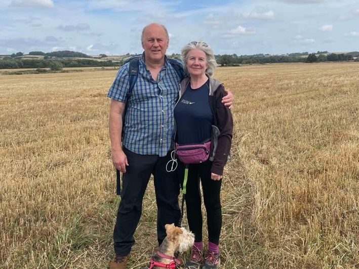 Tony and Julia in a field with their dog