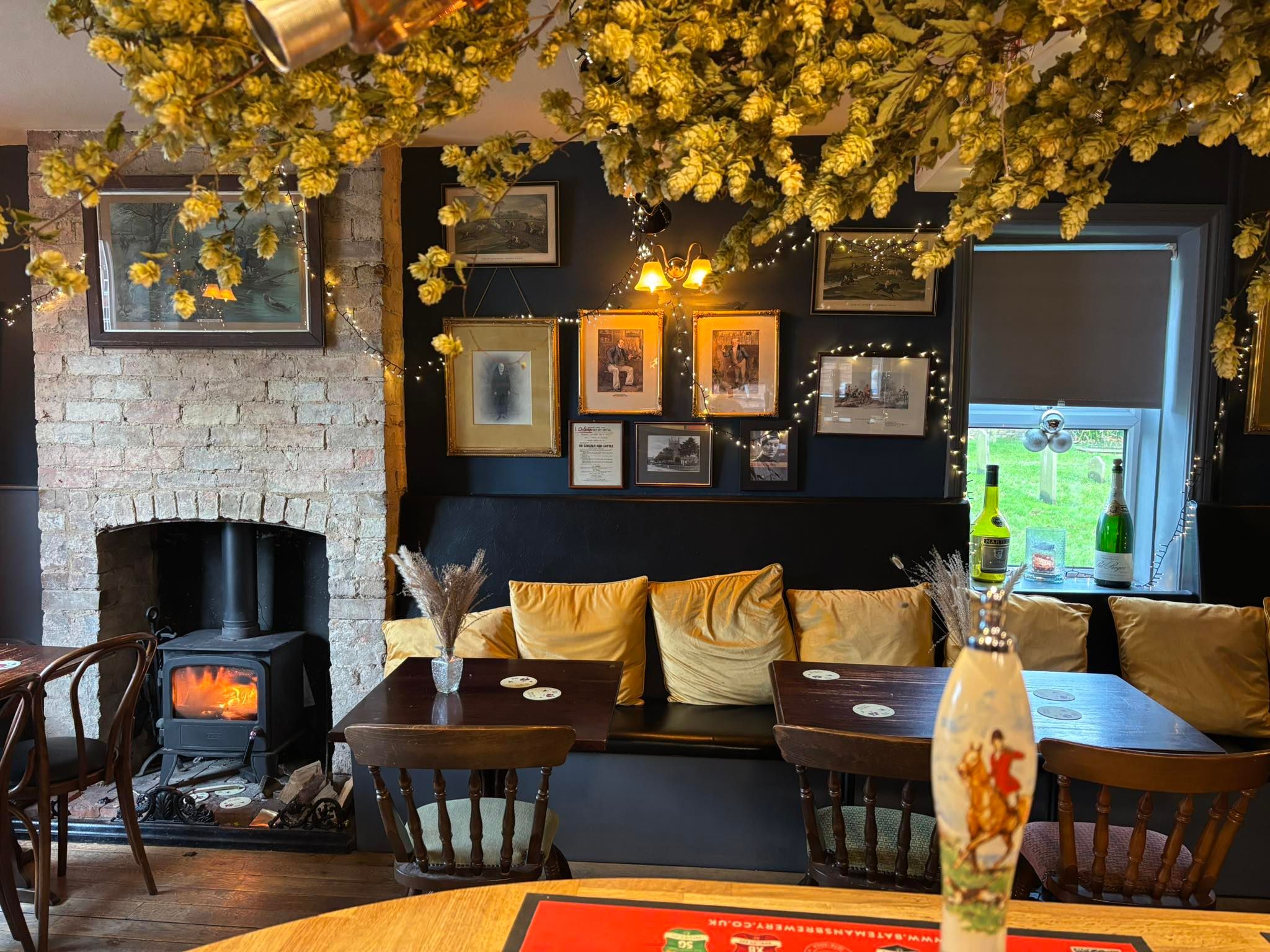 inside The Bottle & Glass pub in Normanby by Spitalin with a roaring fire in the log burner and lots of soft furnishings