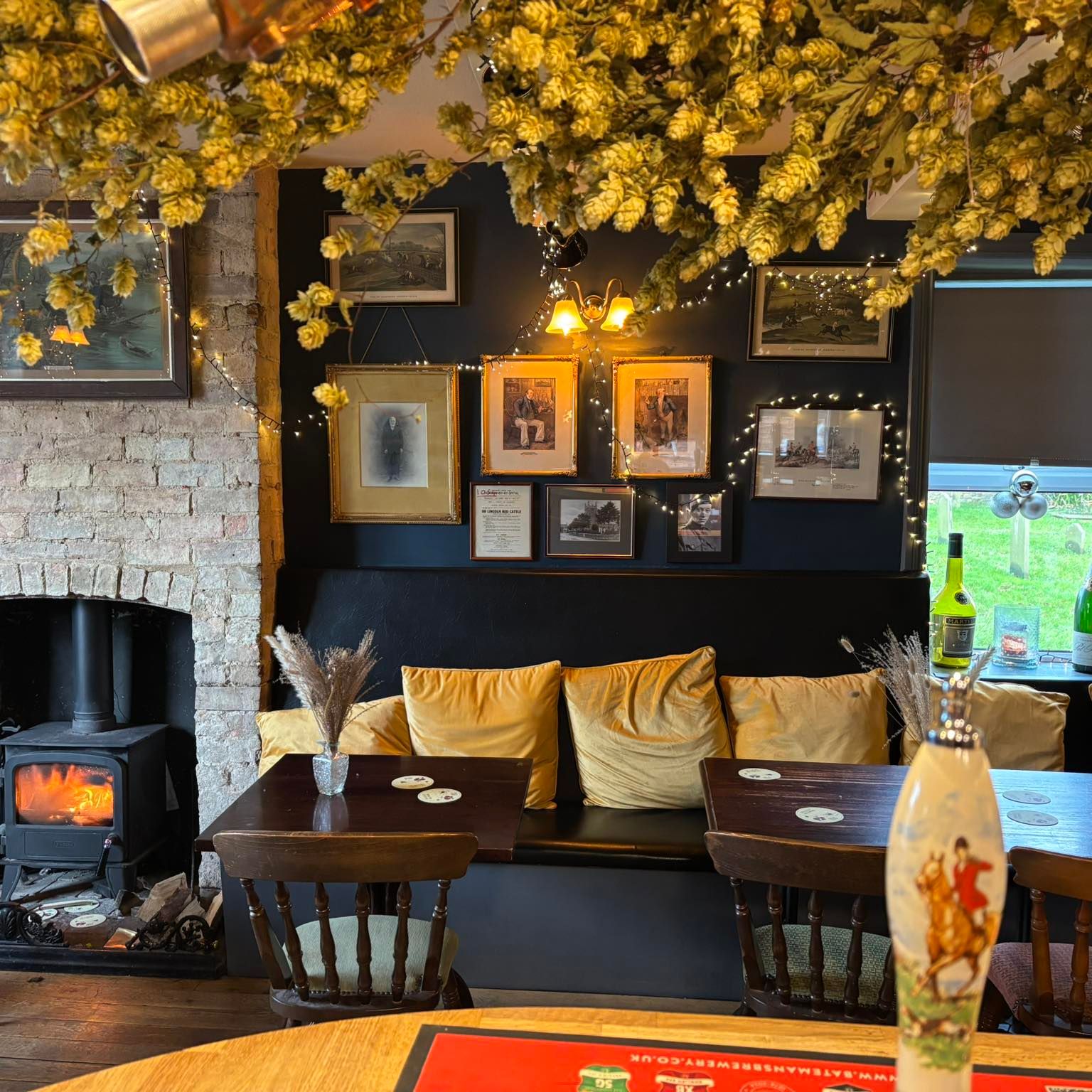 inside The Bottle & Glass pub in Normanby by Spitalin with a roaring fire in the log burner and lots of soft furnishings