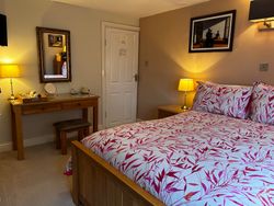 Bed, dressing table, stool and mirror and entrance door of Bedroom 2