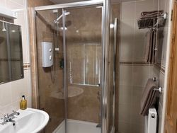 Shower, wash basin and mirror and towels on towel rail in Bedroom 2 en-suite of Bedroom 2