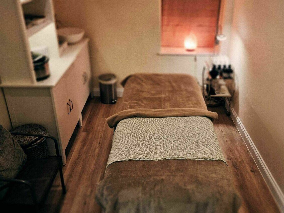 Room with bed, candle for massages and facials