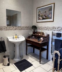 Sink, mirror, table and towel rail in Bedroom 3 Private Bathroom