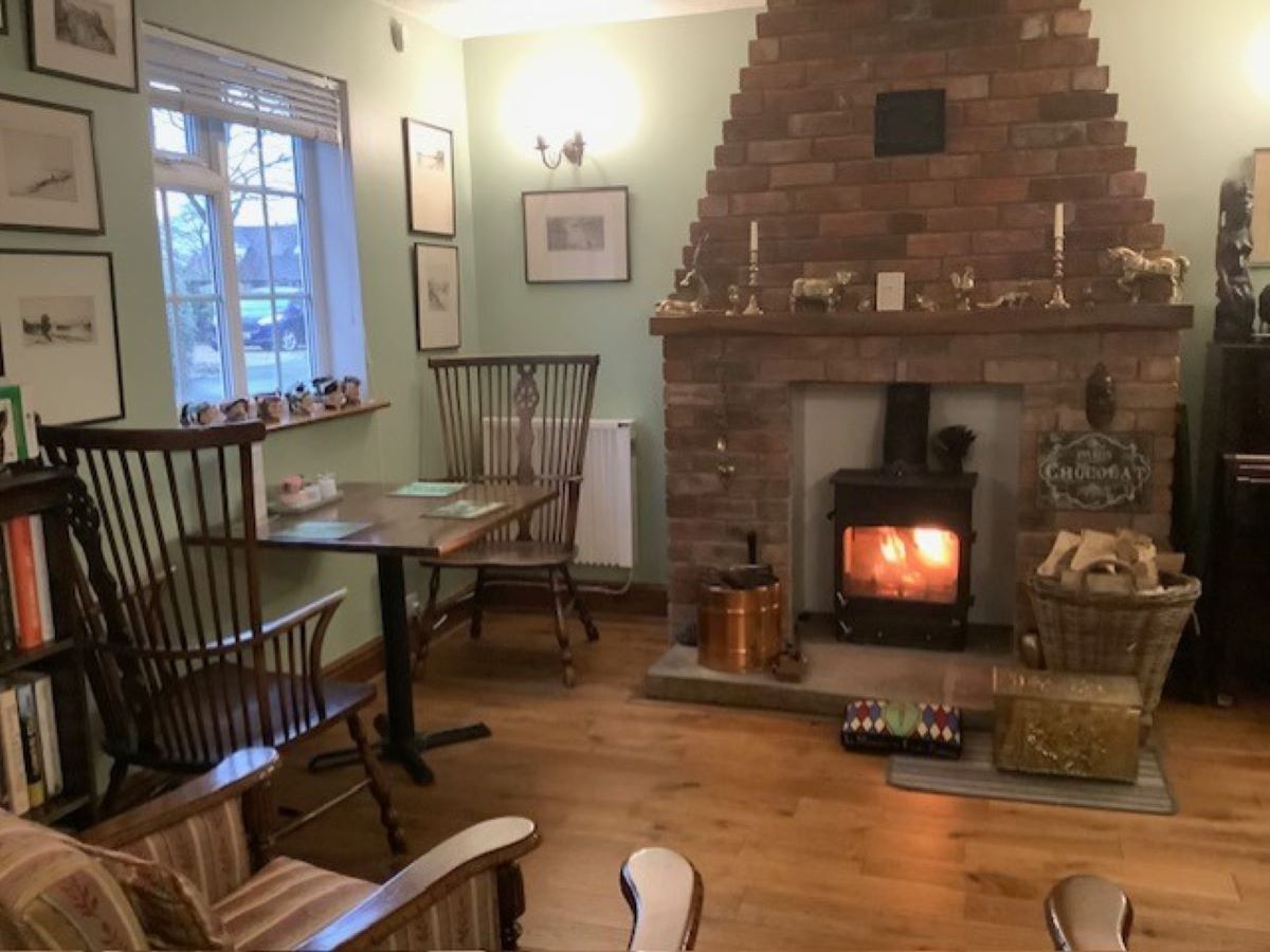 Cozy dining room with a wood-burning stove and brick fireplace