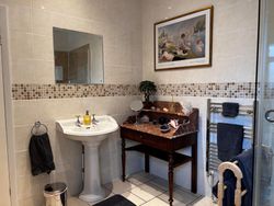 Sink, mirror, table and towel rail in Bedroom 3 Private Bathroom