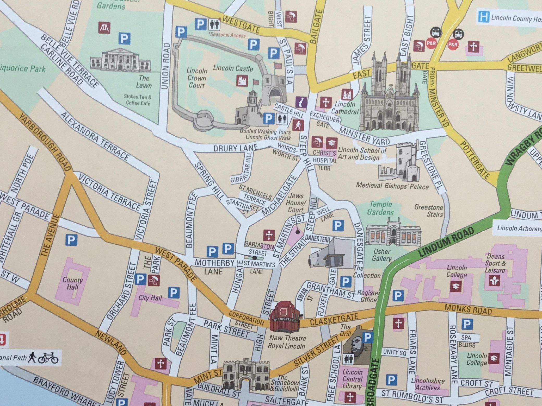 A detailed illustrated street map of Lincoln city center, showing roads, buildings, parking, and points of interest.
