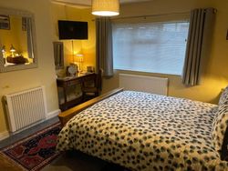 Kingsize bed in Bedroom 3 with dressing table and TV and window