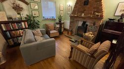 Armchairs and sofa in the Dining Room in front of stove