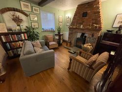 Armchairs and sofa in the Dining Room in front of stove