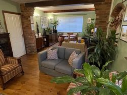 View of the Dining Room from the end with the stve looking towards the window at the front of the house- seating for relaxing and Dining Table and plants