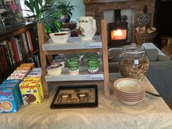 cereals, homemade granola and yoghurts in front of a roaring fire