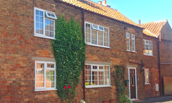 The Old Posthouse B&B building with windows, door and roof