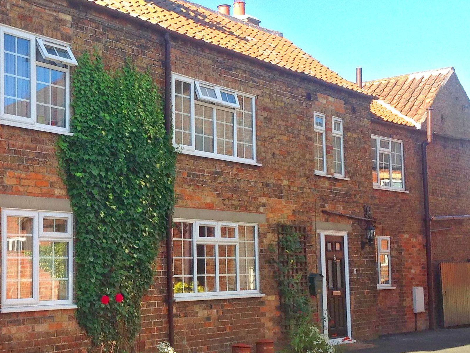 The Old Posthouse B&B building with windows, door and roof
