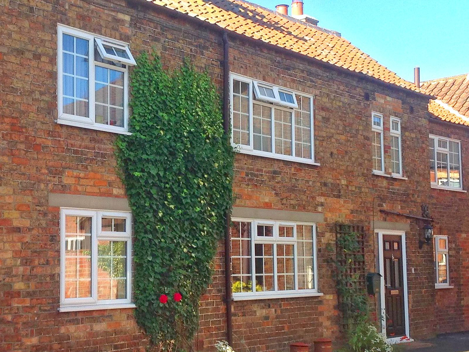 The Old Posthouse B&B building with windows, door and roof