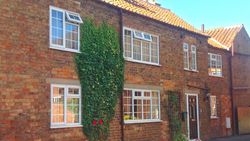 The Old Posthouse B&B building with windows, door and roof