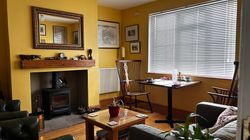 Snug with table for 2 for breakfast, chairs and sofa for guests' use and a log burner