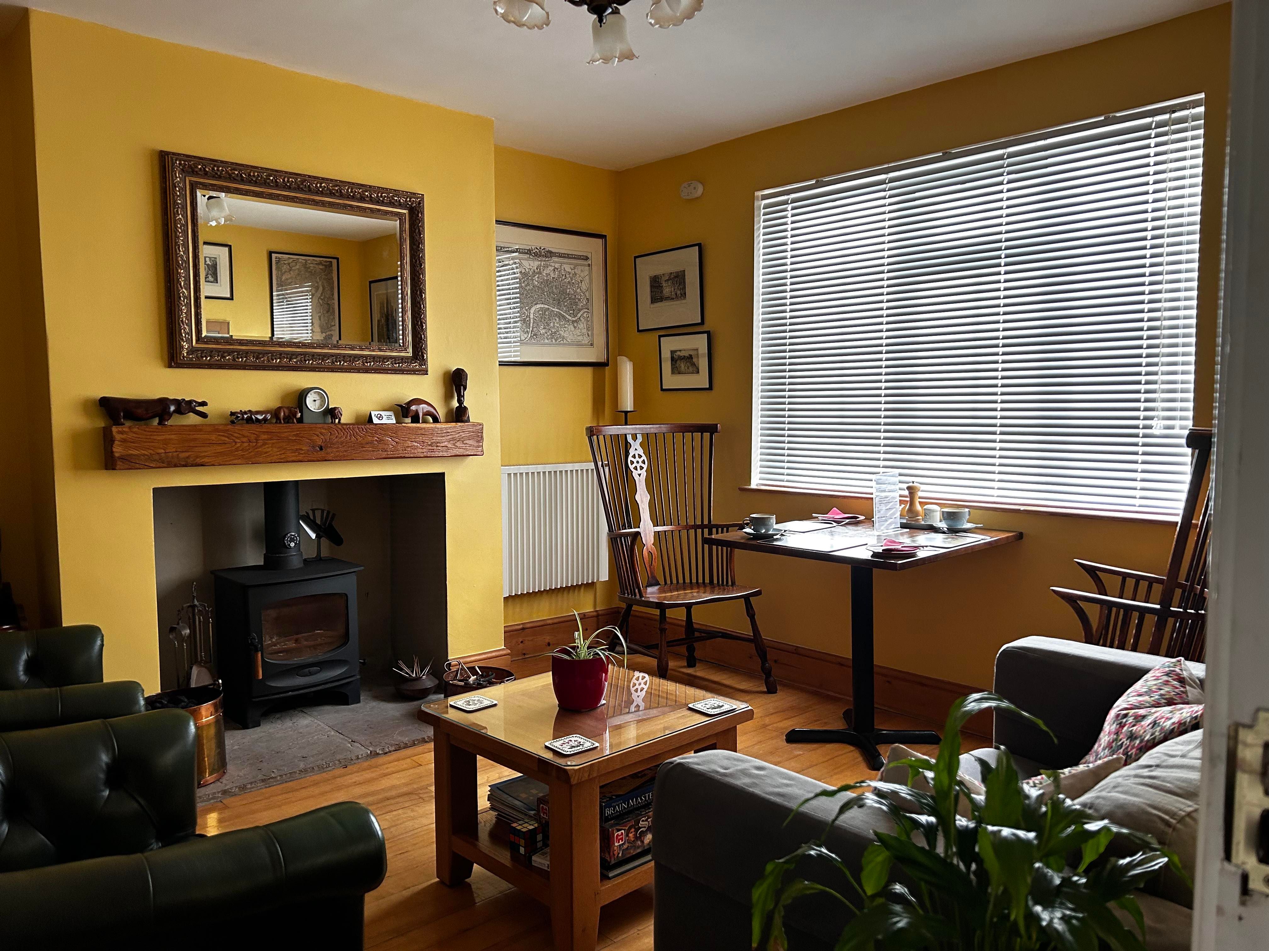 Snug with table for 2 for breakfast, chairs and sofa for guests' use and a log burner