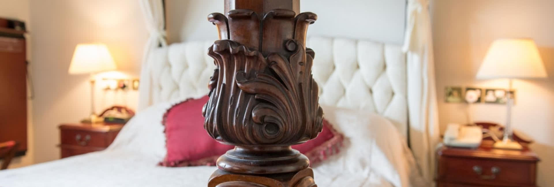 A close up of a four poster bed.