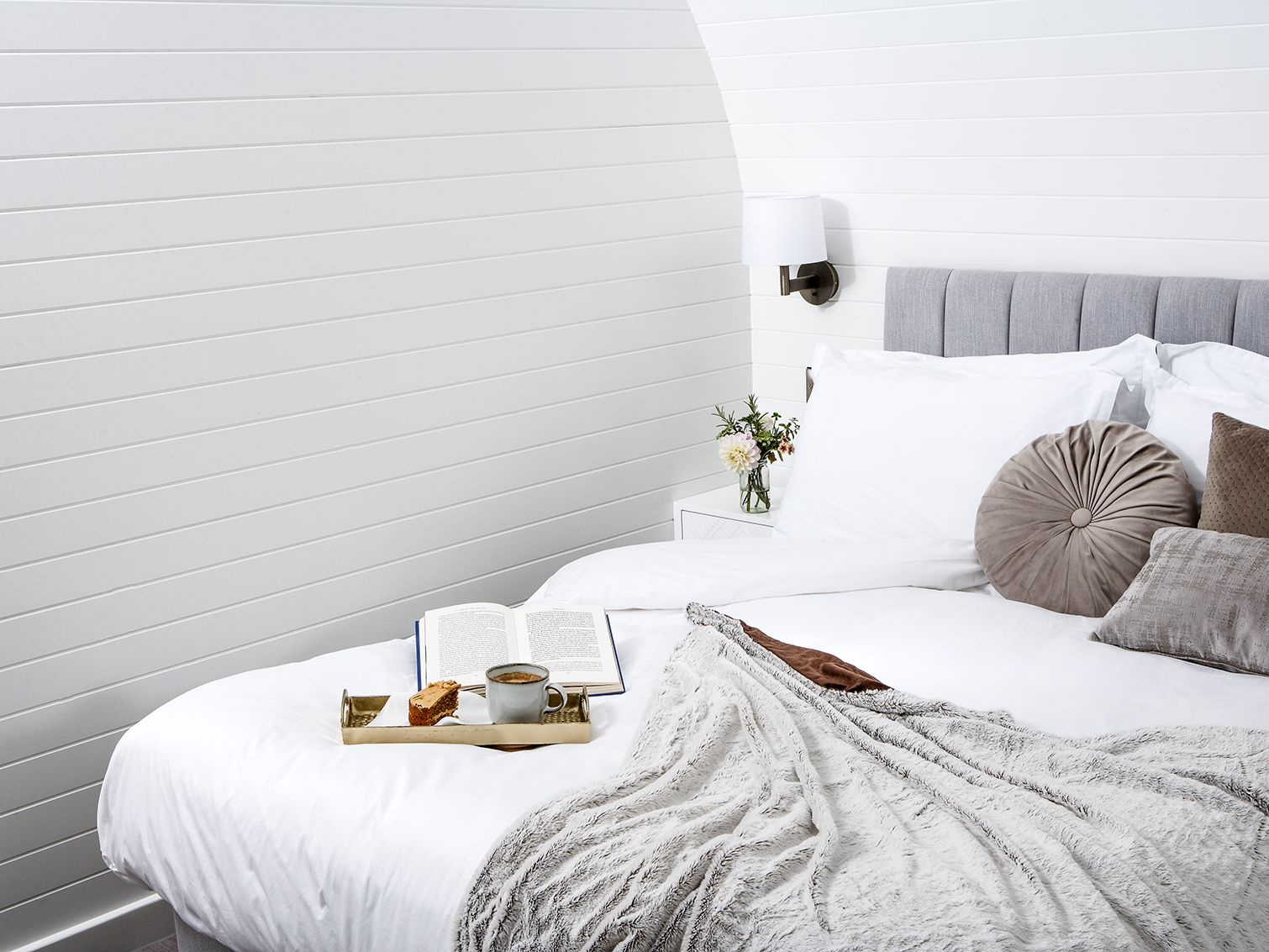 Bed with book and tea tray