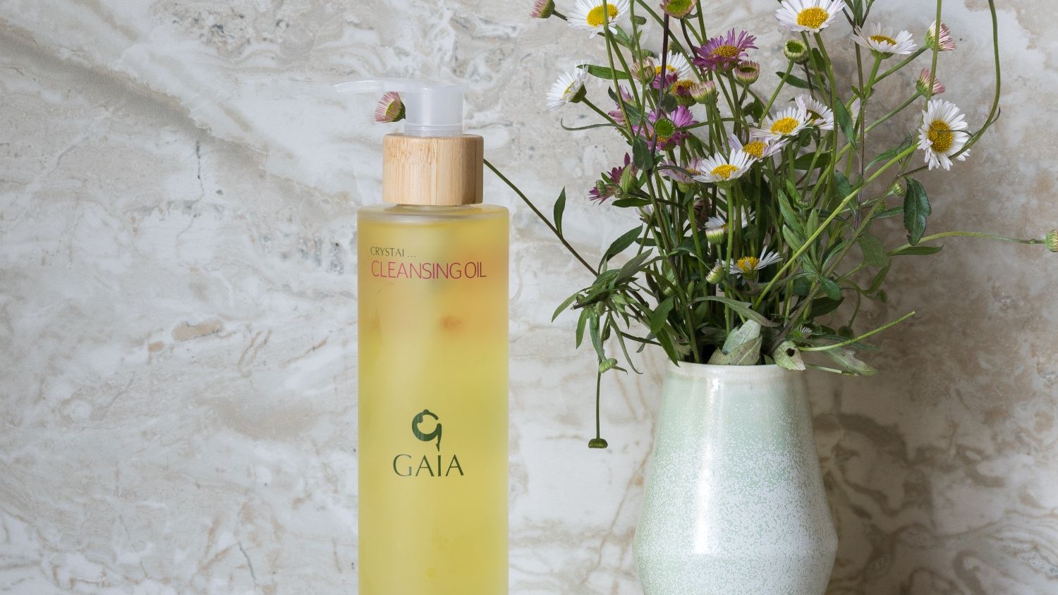 stones, cleansing oils and flowers in a vase