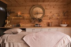 Treatment bed with products and fairy lights on counter