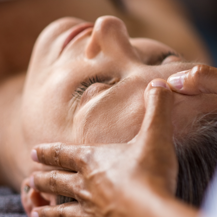 Woman receiving a pressure point facial
