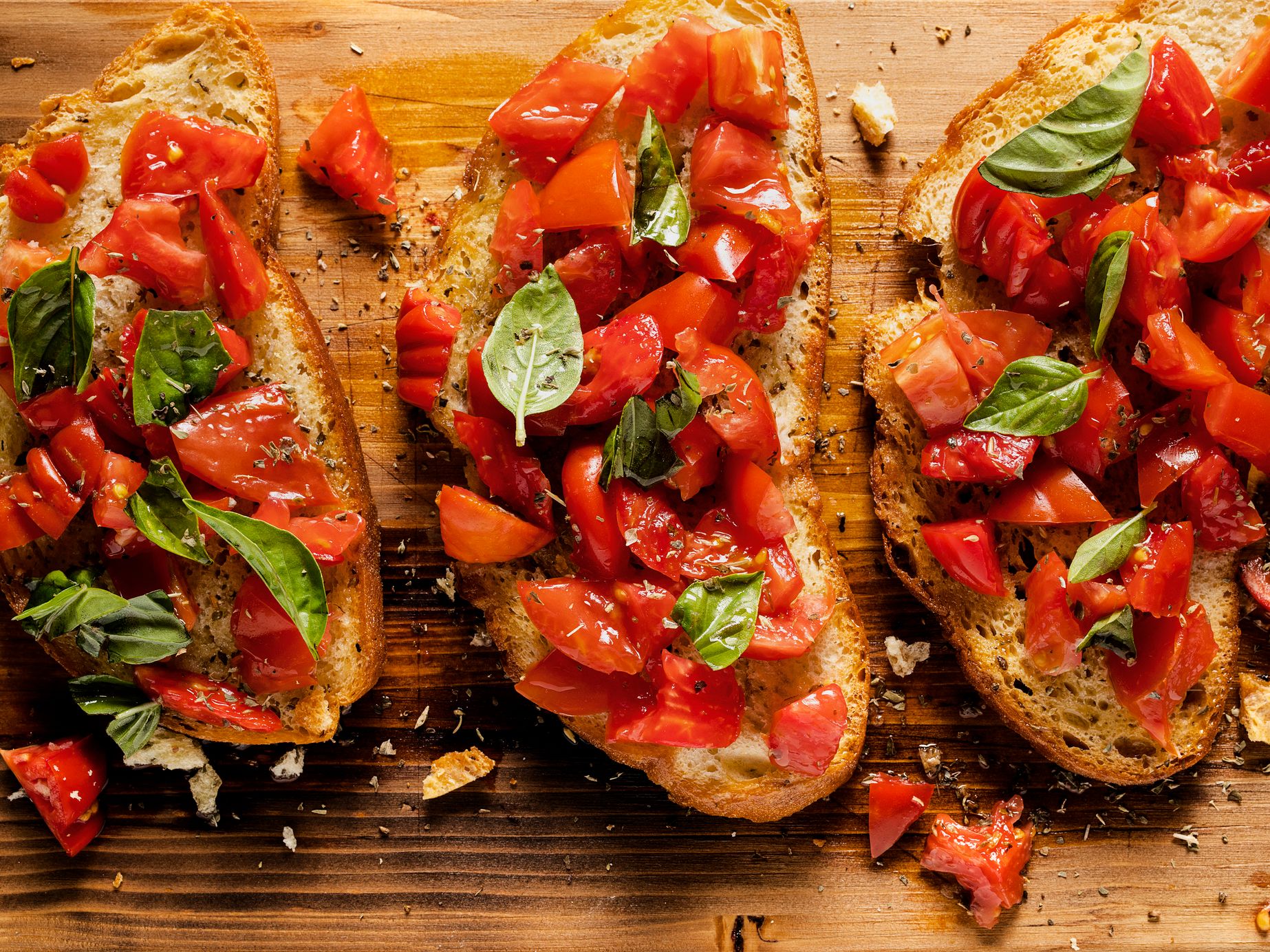 Tomato and basil bruschetta on a rustic wooden chopping board