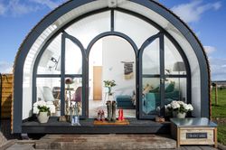 Glamping pod with wellies on doorstep