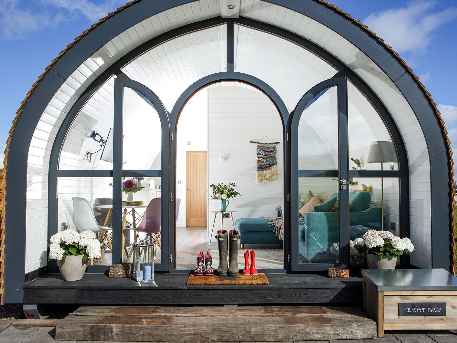 Glamping pod with wellies on doorstep