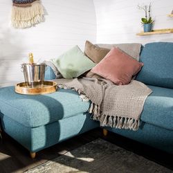 Living area with with vase of flowers, and bucket with champagne on sofa