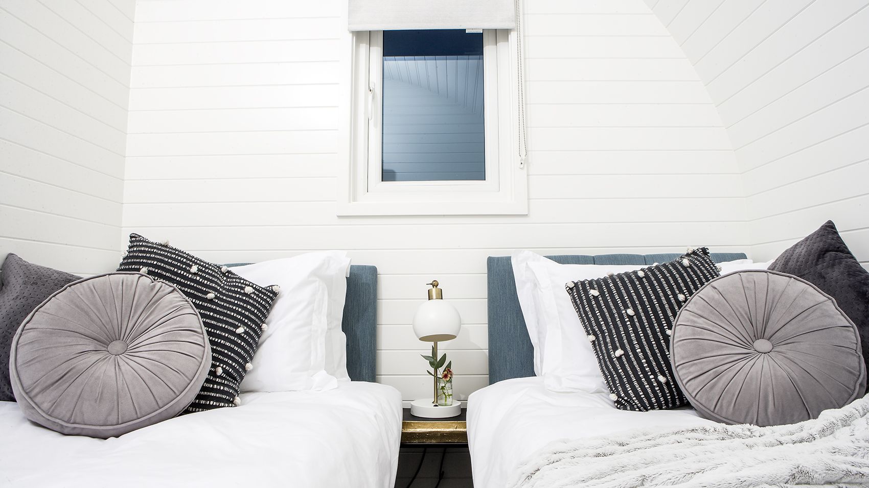 Twin beds with grey pillows