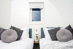 Twin beds with grey pillows