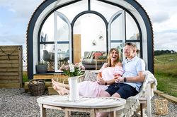 Couple sat outside Heather Pod
