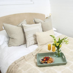 Tray with breakfast and flowers on bed