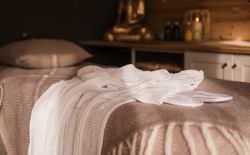 Towels on bed in spa treatment room