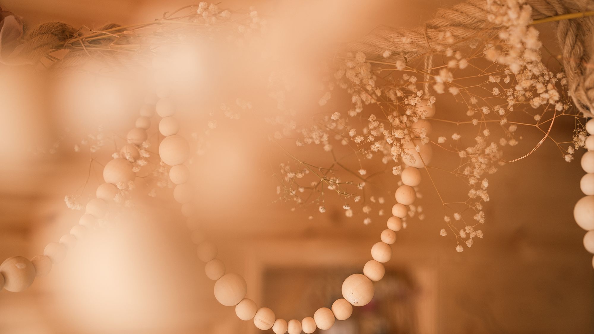 Wooden beads and dried flowers hung from ceiling