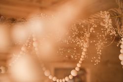 Wooden beads and dried flowers hung from ceiling