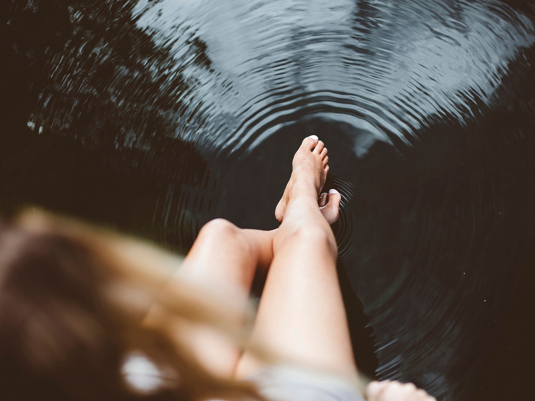 Feet in water creating ripples