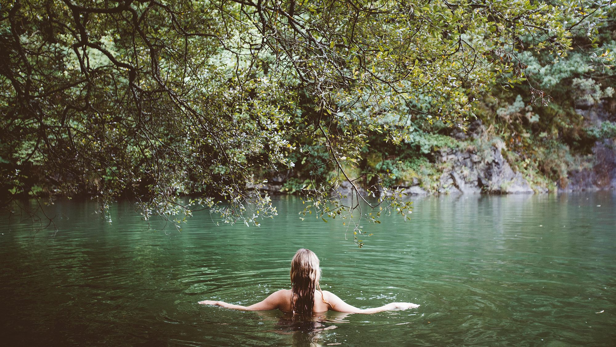Person in natural water pool