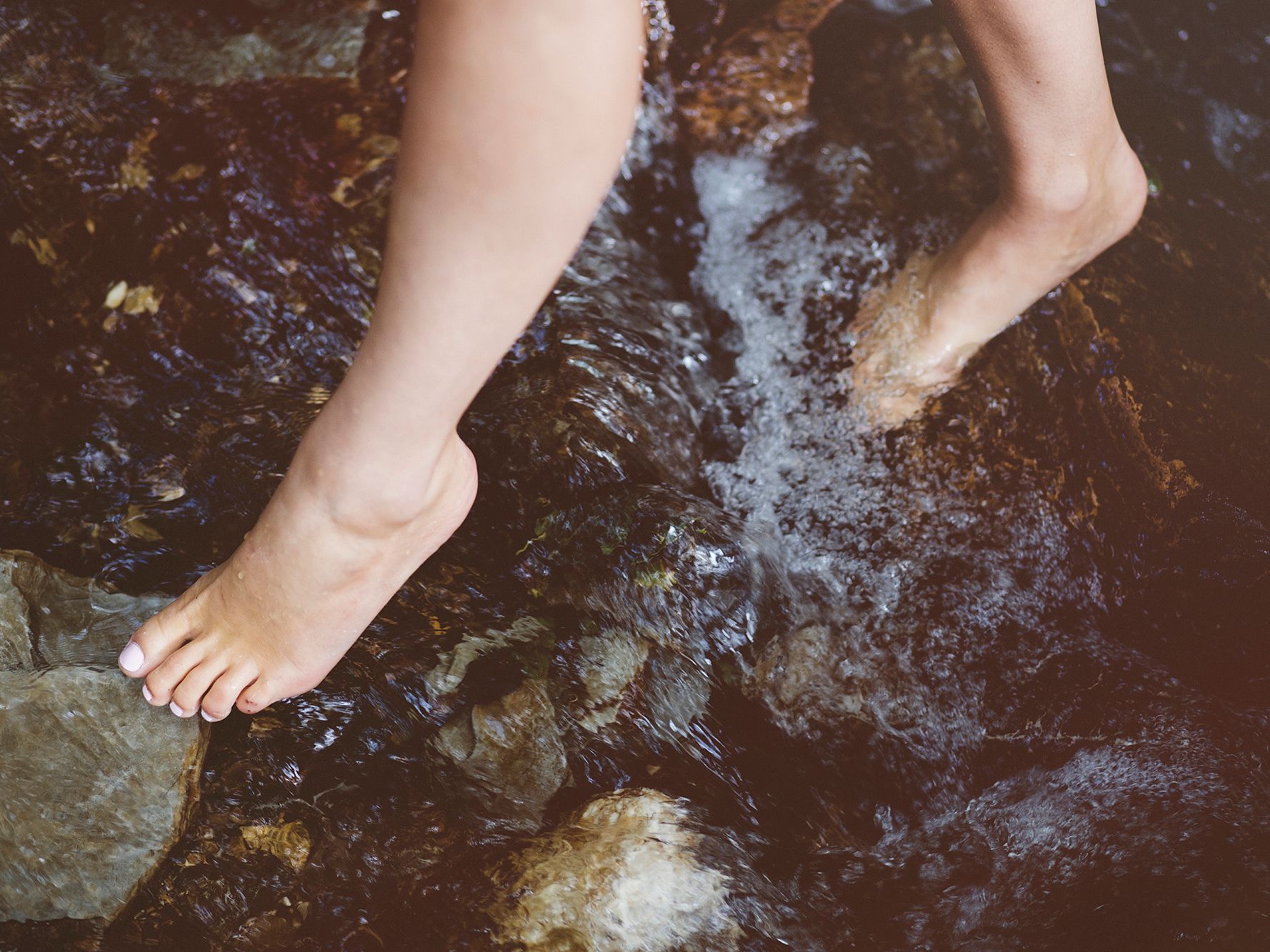 Feet in rock pool