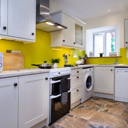 Kitchen with oven, microwave, washing machine