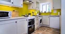 Kitchen with oven, microwave, washing machine