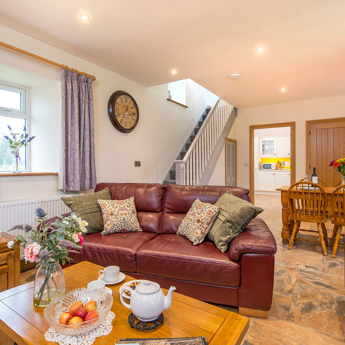 Living Area in Towy cottage with leather sofas and a dining table with 6 chairs