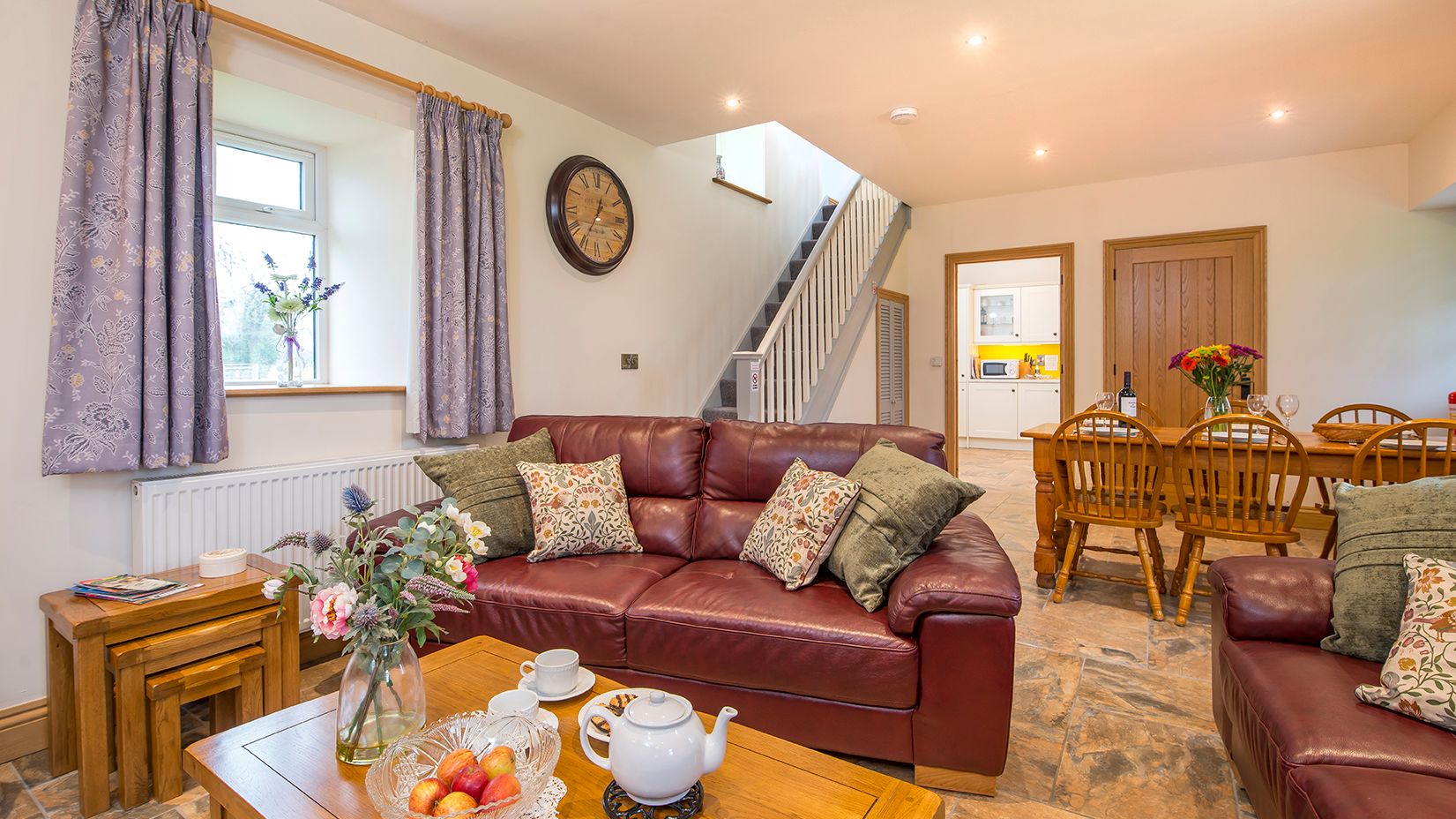 Living Area in Towy cottage with leather sofas and a dining table with 6 chairs