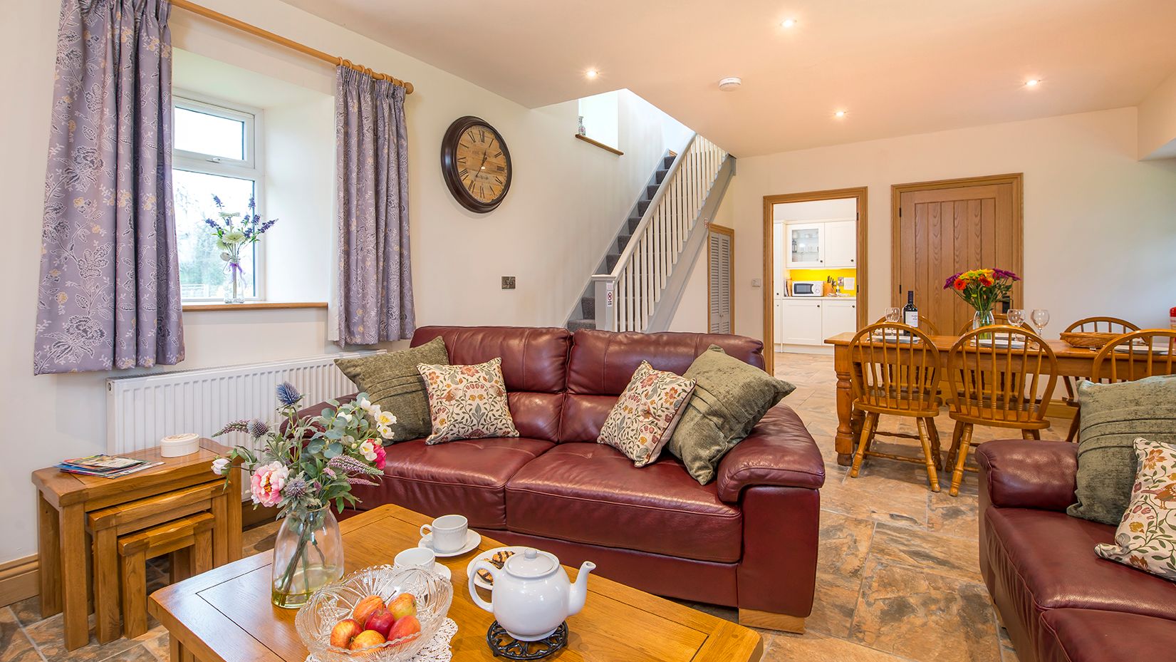 Living Area in Towy cottage with leather sofas and a dining table with 6 chairs