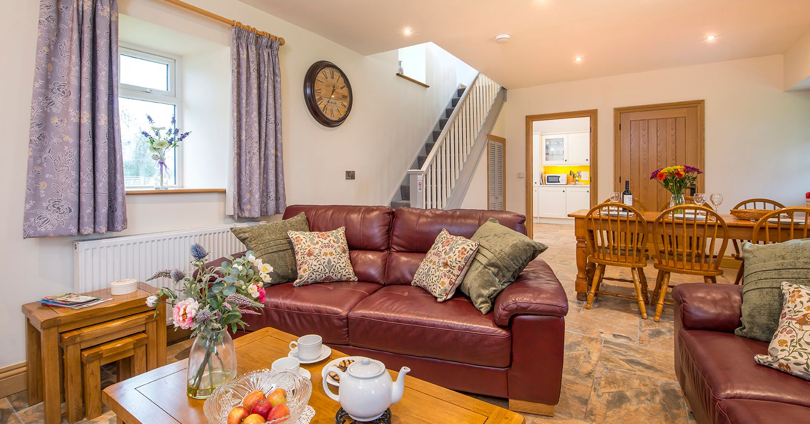Living Area in Towy cottage with leather sofas and a dining table with 6 chairs
