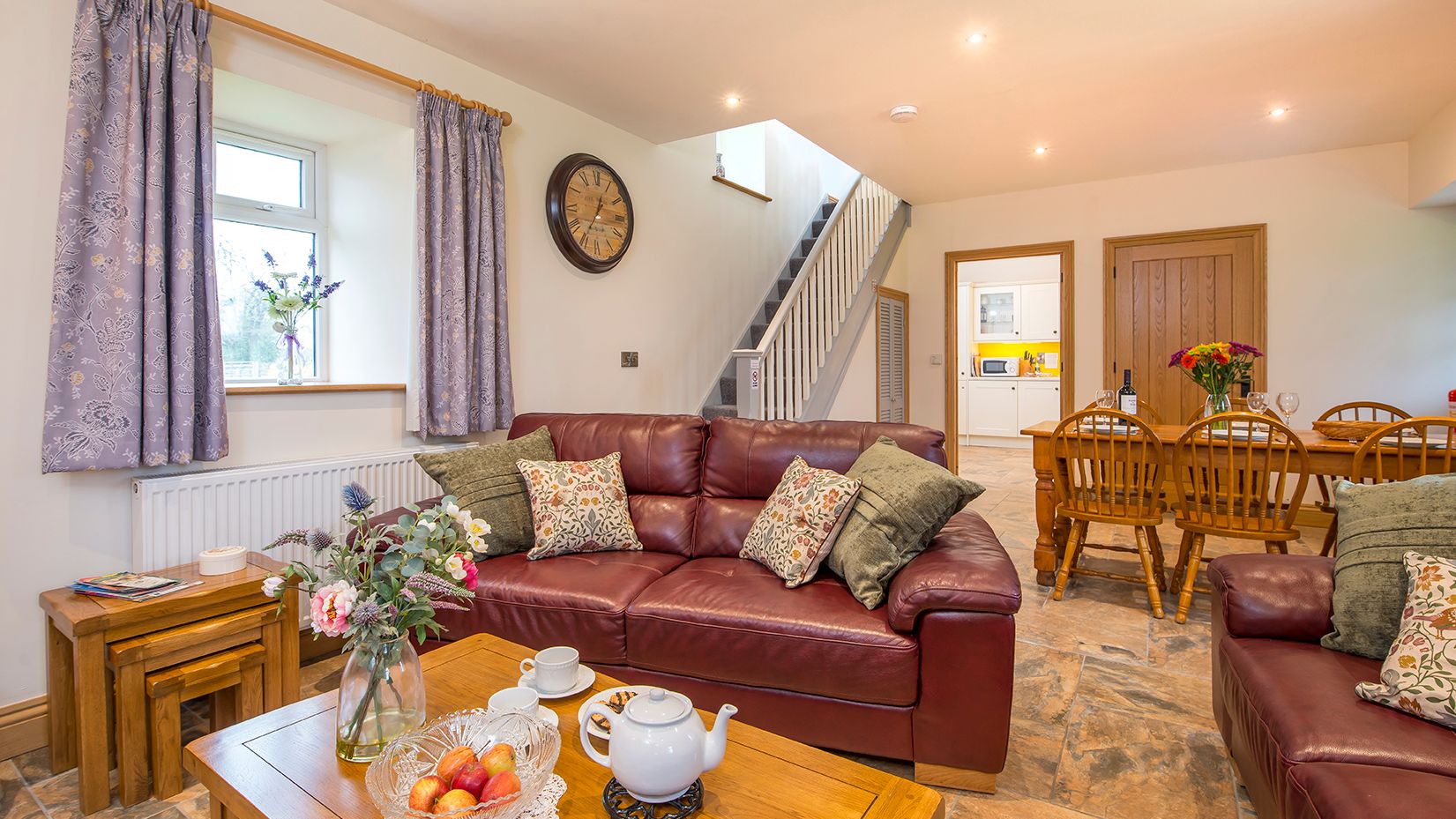 Living Area in Towy cottage with leather sofas and a dining table with 6 chairs