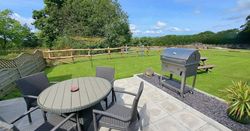 BBQ and set of table and chairs in Cothi Cottage Garden