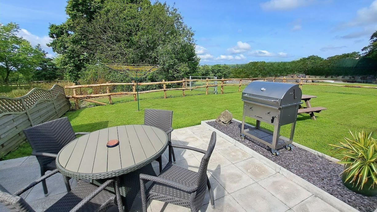 BBQ and set of table and chairs in Cothi Cottage Garden