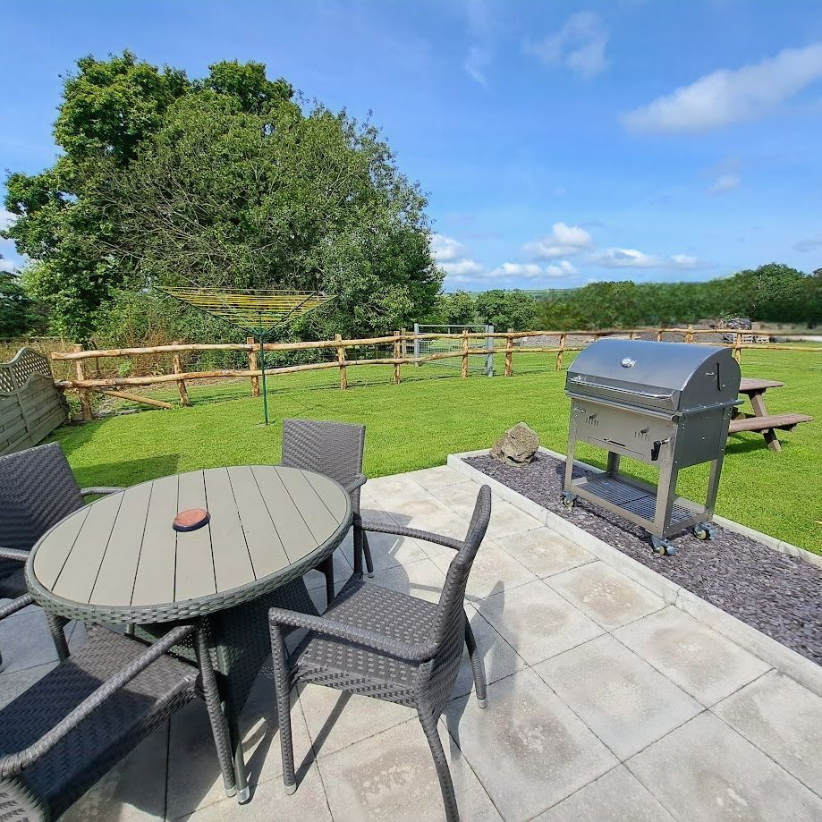 BBQ and set of table and chairs in Cothi Cottage Garden